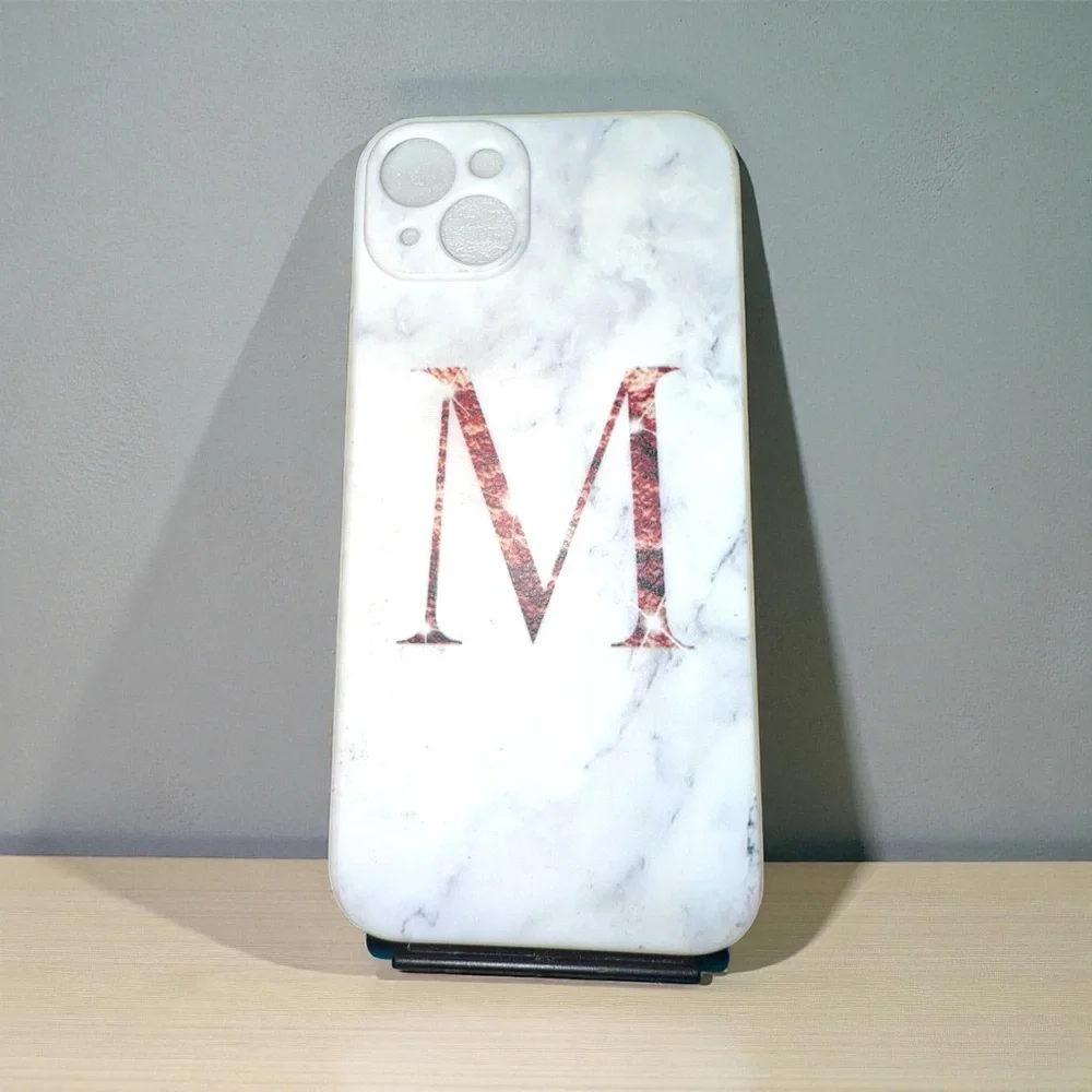 White marble pattern iPhone 13 Pro Max case with a large Rose Gold Letter M